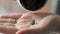 Spirulina pills falling in woman hand slow motion