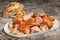 Spit Roasted Pork Shoulder Slices Served With Torn Leavened Pitta Flatbread On Old Weathered Flaky Garden Table