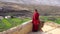 Spiti, Himachal Pradesh - 2 july 2022- A Tibetan monk standing on the roof of key monastery. A tibetan monk with red color dress