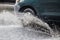 Splash by a car as it goes through flood water