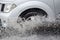 Splash by a car as it goes through flood water