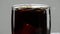 A splash of ice cold Cola - Ice cubes fall in a glass of soda