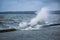 Splash of a large wave on the flooded embankment of the resort city on the Black Sea