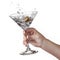 Splash of martini in womans hand isolated