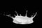 Splash of milk in the form of milk crown. Milk pouring splash isolated on black background