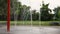 Splash pad and swings in a public park with a running child