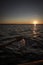 Splash from rowing wooden oar on boat on a lake during sunset