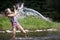 Splash! A young girl gets soaked by water