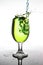 Splashing green water in wine glass