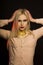 Splendid blonde model with long hair and gold foil on her neck