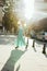 Splendid blonde woman in fashionable dress walking at the city i