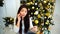 Splendid Girl Talking on Phone And Ordering Gifts, Sits on Background Decorated Christmas Tree and Fireplace in Bright
