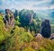 Splendid morning view of sandstone cliff in Saxony Switzerland with Bastei bridge. Foggy summer scene rocky mountains, Germany, Sa