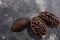 Split fermented cocoa pod with shelled cacao beans atop dark grey backdrop,  top view