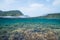 Split-level underwater shot of healthy coral reef in clear tropical water, Okinawa, Japan