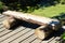 A split log wooden bench on a boardwalk trail