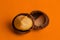 split macadamia nut close-up on an orange background