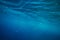 Split shot of blue ocean water surface underwater