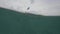 Split shot of a woman paddling the kayak in calm sea with underwater view.