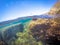 Split underwater view of Alghero rocky shore