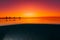 Split view with colorful sunset and underwater sandy sea bottom