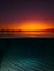Split view with colorful sunset and underwater sandy sea bottom