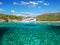 Split view - half underwater view of beautiful seabed with sea fishes and beautiful marine yacht, Turkey, Bodrum