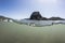 Split View of Lion Rock Piha Beach