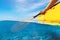 Split view of person kayaking in transparent blue sea, underwater and above water photography of kayak and paddle in warm summer