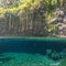 Split view of Piula Cave Pool swimming hole with a fish swimming