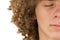 Splited in half cropped portrait of a young curly European man with long curly hair and closed eyes close up. very lush male hair