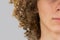 Splited in half cropped portrait of a young curly European man with long curly hair and closed eyes close up. very lush male hair