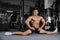 Splits stretches man stretching legs in the gym handsome fitness