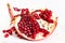Splitted pomegranate fruit on plate on white