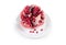 Splitted  pomegranate fruit on the white dish on white background