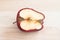 Spoiled bad red apple on wooden background