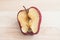 Spoiled bad red apple on wooden background