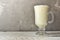 Spoiled milk. Kefir. Ayran in a glass Glass transparent glass. Free space for text. Light gray background