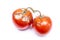 Spoiled tomatoes with green tails on an isolated white background.