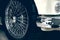 Spoked wheel of a white luxury car. Antique automovile and empty copy space