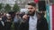 Spokesman on stage speaks via microphone with protesting strike crowd in Russia