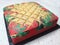 Sponge cake with colourful random patterns. Placed on a white table.