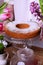 Sponge cake sprinkled with sugar powder surrounded by flowers