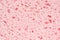 Sponge pink texture background. Bath spongy surface. Kitchen sponge material closeup. Foam rubber detail. Close up