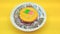 Sponge roll cake isolated on yellow background
