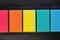 Sponges of different colors in dark background, top view.