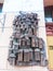 Spontaneous tribute in a street to the city of Valparaiso, made with pieces of bronze and glued to the wall