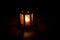 Spooky candle lamp with star shaped holes shining from inside. Lighting dimly the floor and projecting shadows