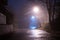 A spooky empty country road, with street lights. On an atmospheric foggy winters night. UK