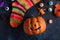 Spooky Halloween banner with a smiling pumpkin, halloween socks and terrible artificial eyes. Picture for funny celebration